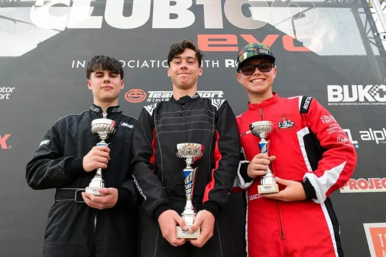 Samuel and two other drivers on the Club100 podium with trophies