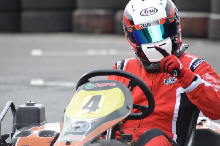 Close-up of Samuel in his kart wearing his helmet