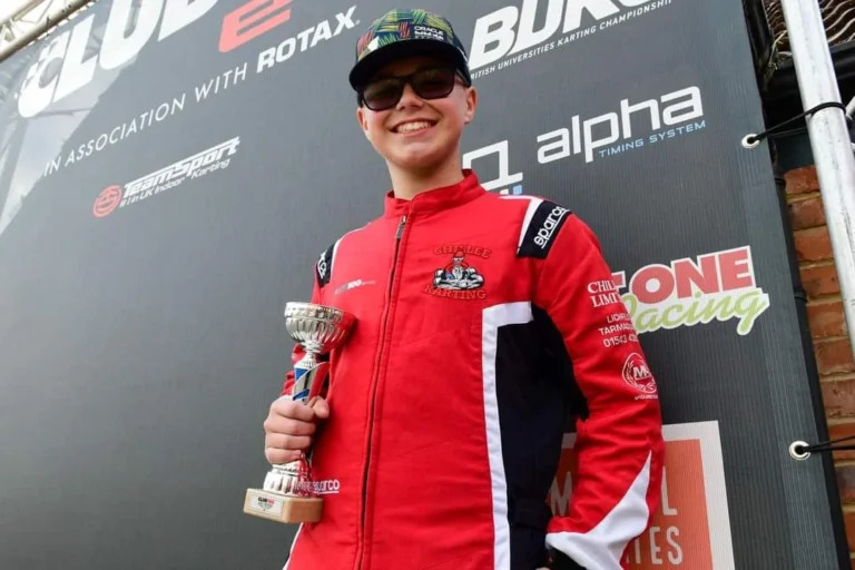 Samuel holding his Club100 trophy