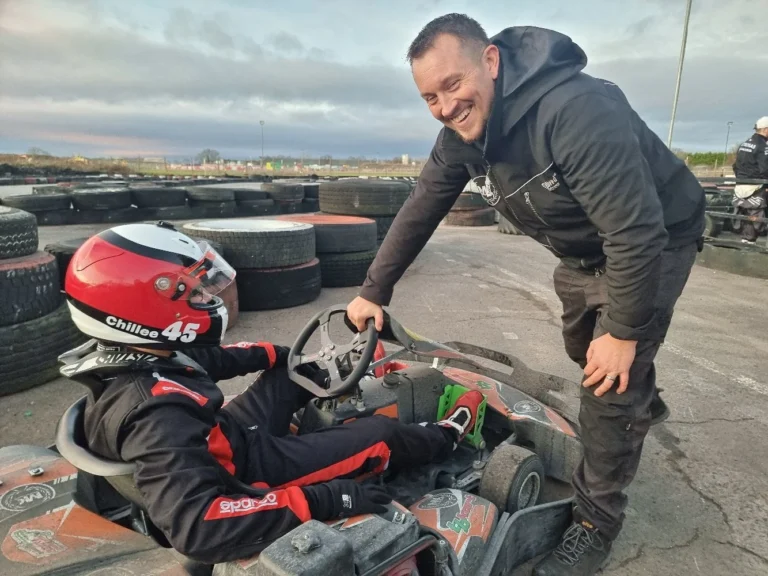Samuel in his kart with his mechanic at the track